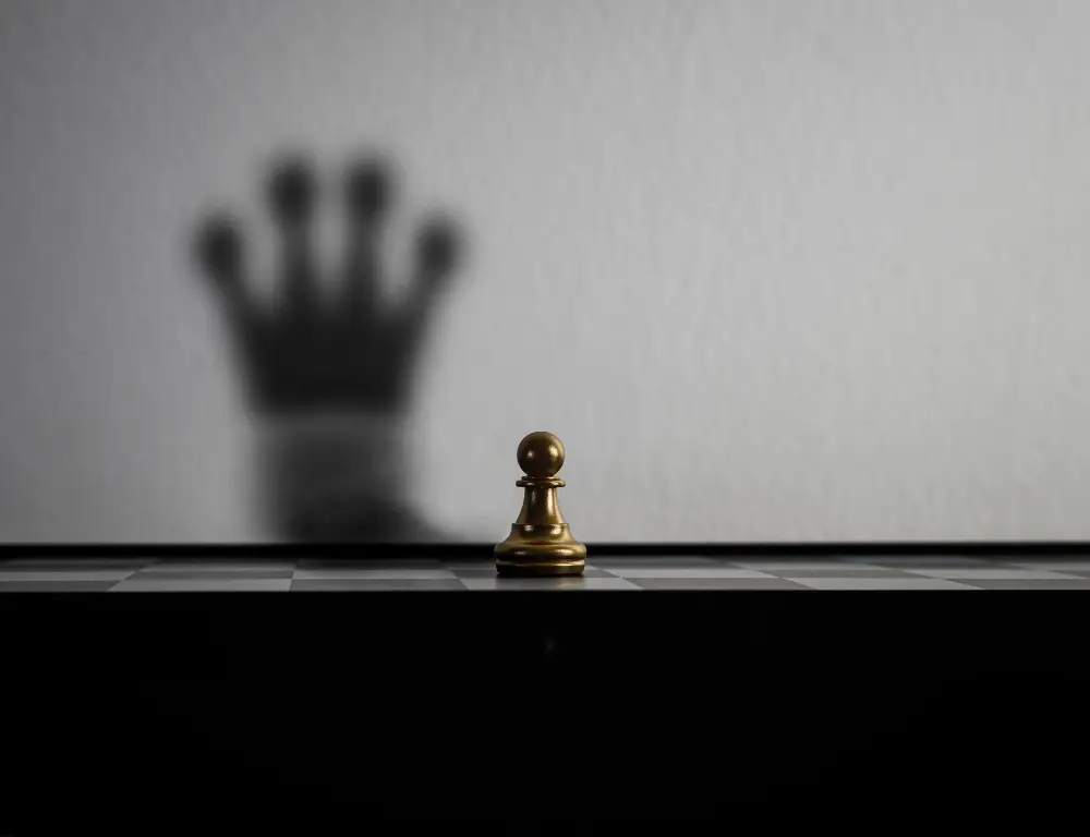 Chess pawn casting a king shadow, symbolizing ambition, strategic execution, and business growth planning.